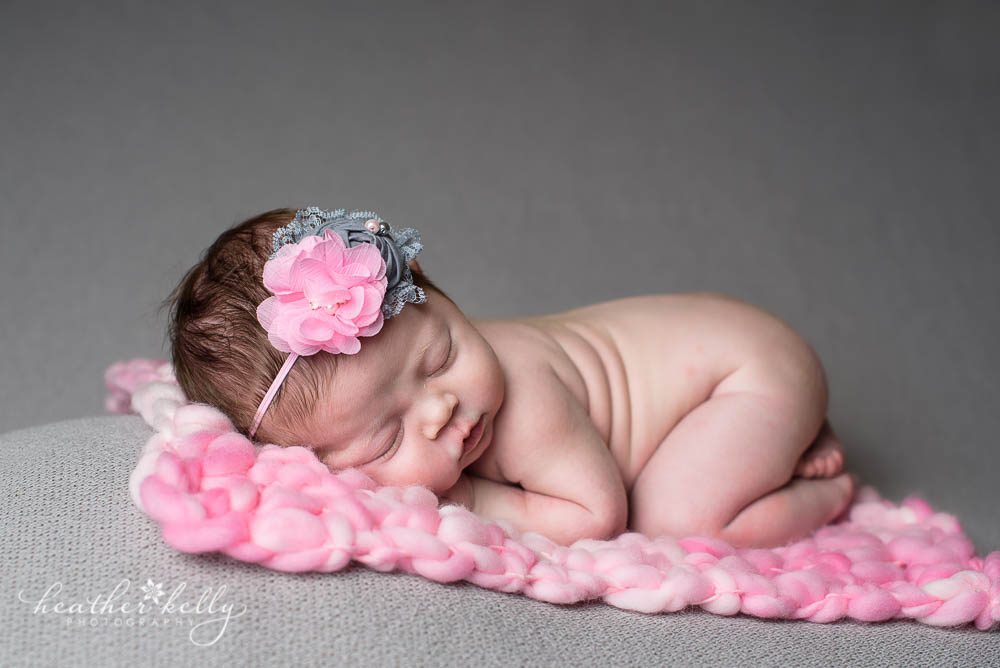 newborn photography session of baby girl on pink and gray