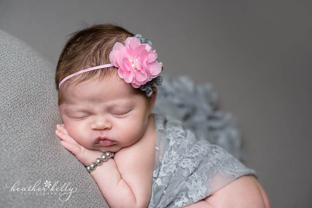 newborn girl on gray blanket photography session