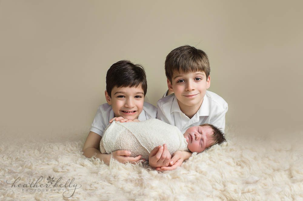 newborn boy with his 2 big brothers