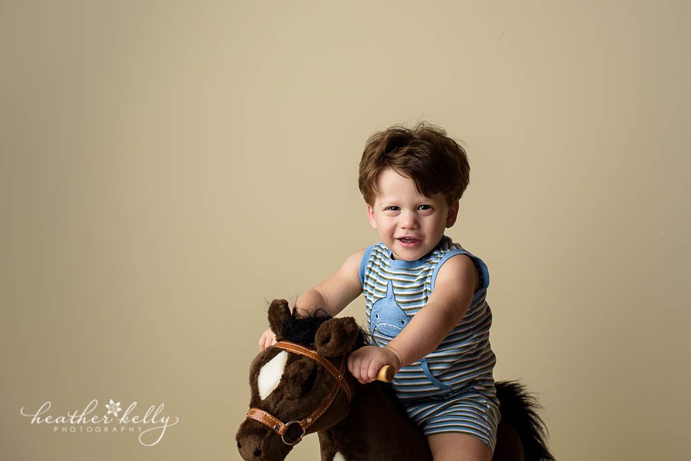 photography session with boy on toy horse