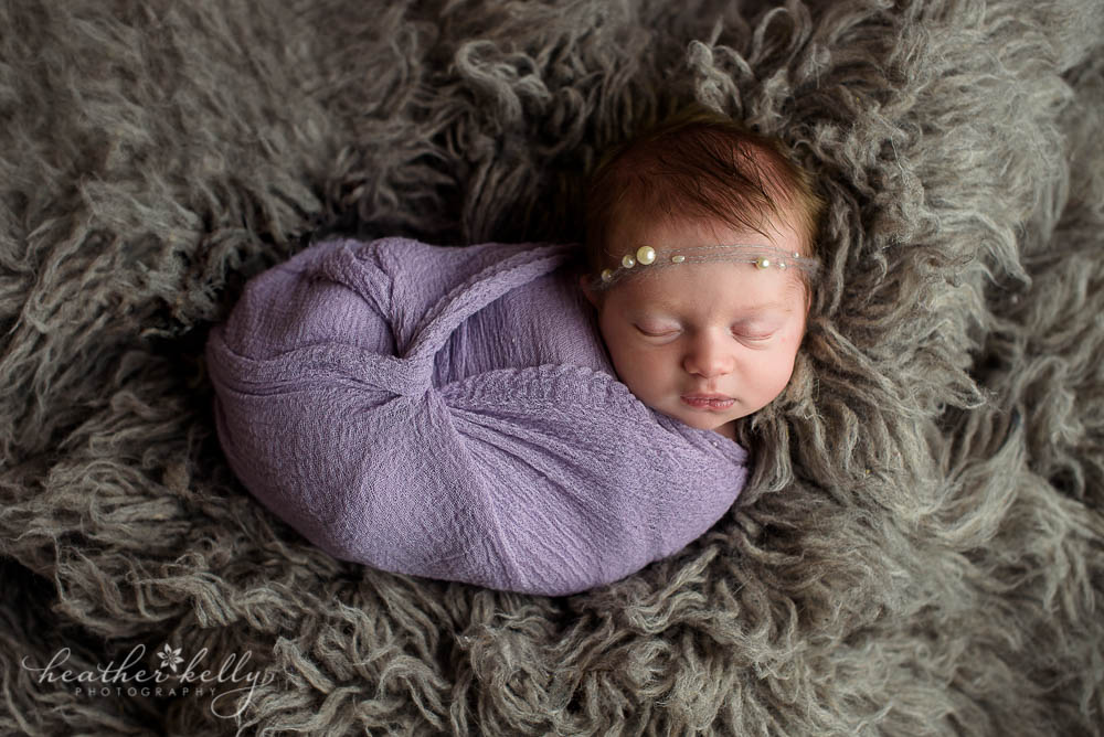 lavender wrapped newborn and gray flokati
