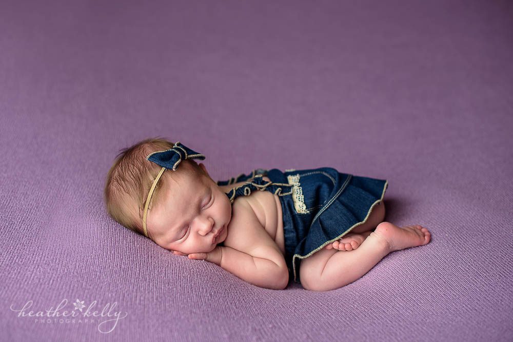 baby girl jean romper in newborn session