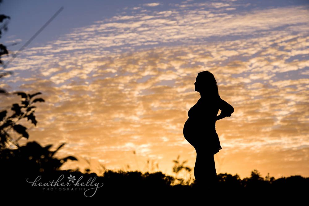 maternity silhouette with gorgeous sunset 