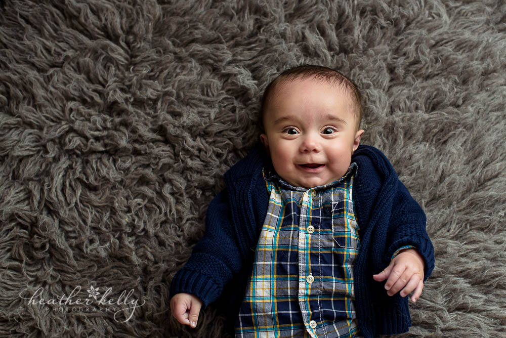 happy baby boy at 6 month milestone session