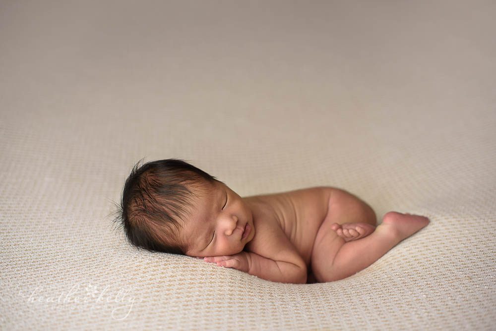 naked newborn boy photo on neutral backdrop