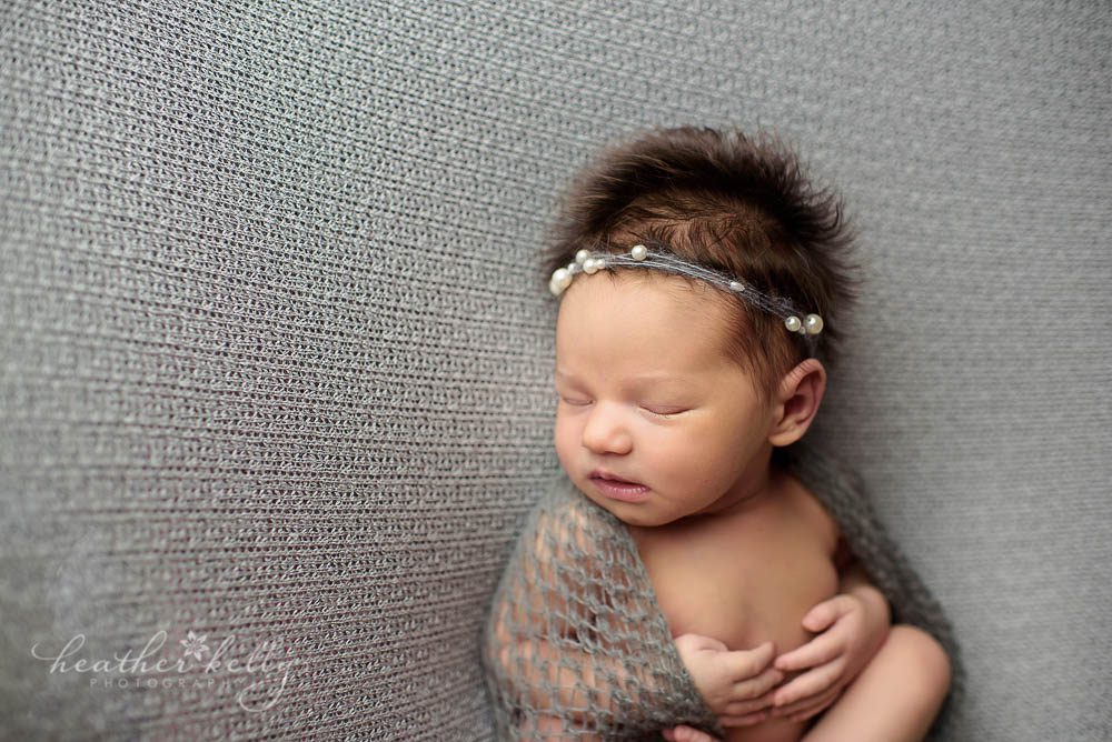 newtown newborn girl with gray wrap and headband photo