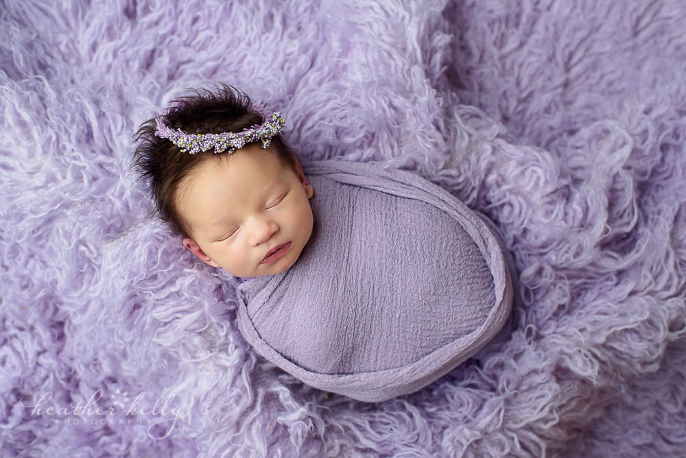 newtown newborn girl photo wrapped in lavender on flokati
