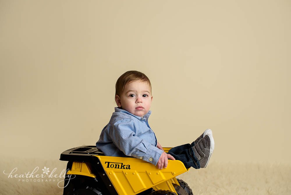 adorable danbury baby boy sitting in his tonka truck photo