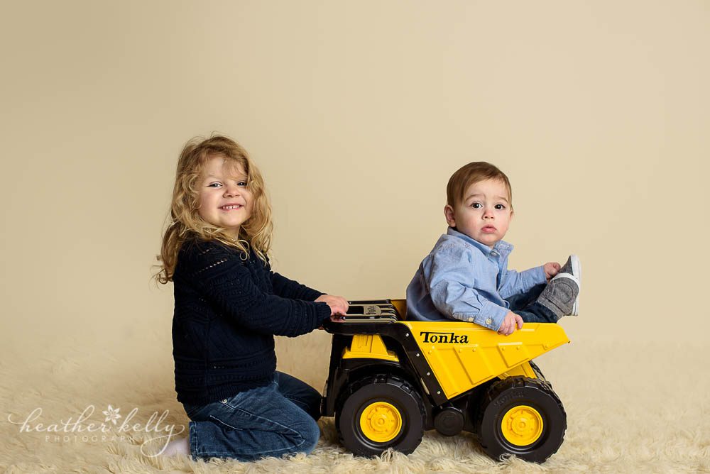 adorable danbury baby with his big sister in tonka truck photo