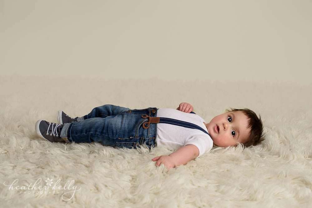 6 month boy laying on cream rug photo monroe baby photos