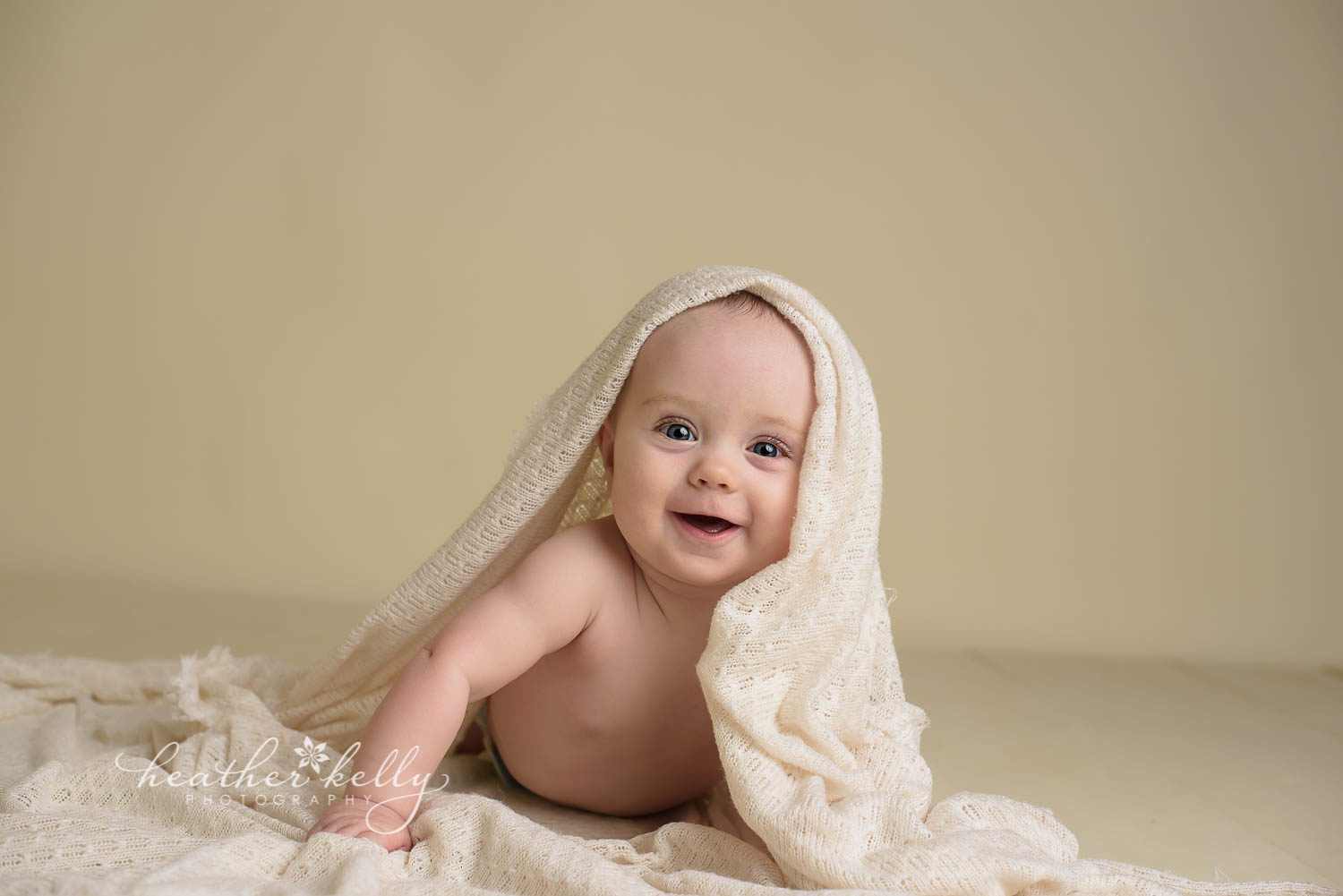 happy 7 month boy doing tummy time with blanket on his head during photo session. newtown baby boy by ct photographer heather kelly photography. 