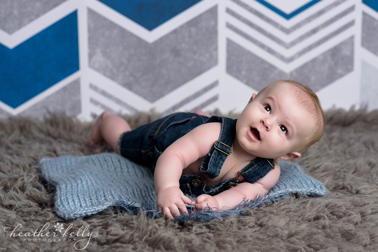 baby boy 6 months about to roll over during photo session. danbury baby boy