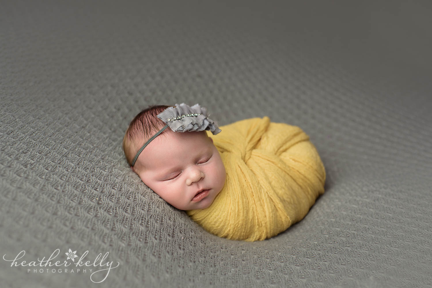 twist wrap newborn girl yellow and gray. newborn wrapping poses