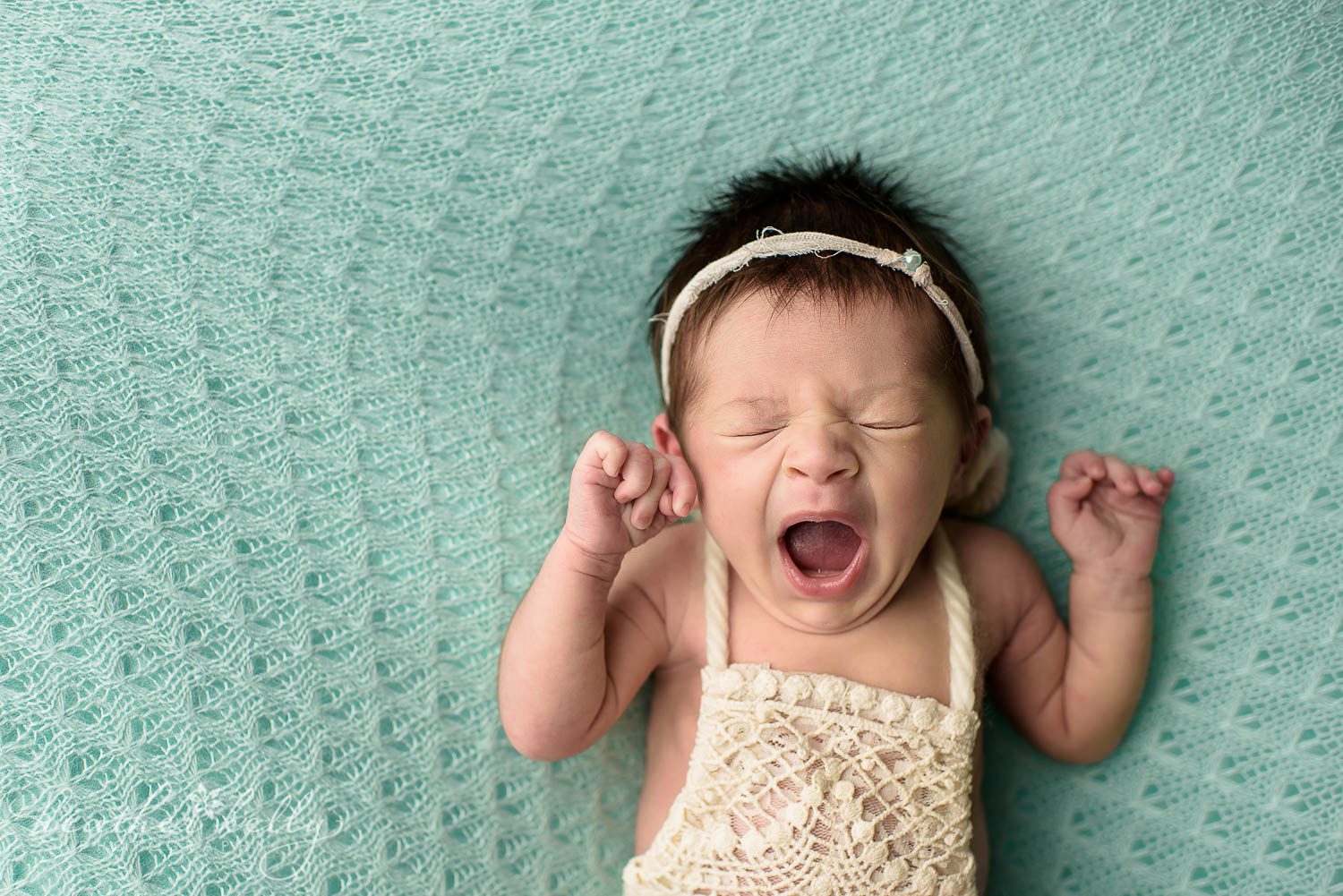 newborn photography poses. newborn girl yawning. back pose. 