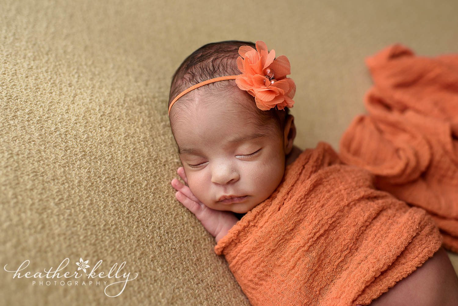 newborn girl wrapped in orange. east hartford baby photographer