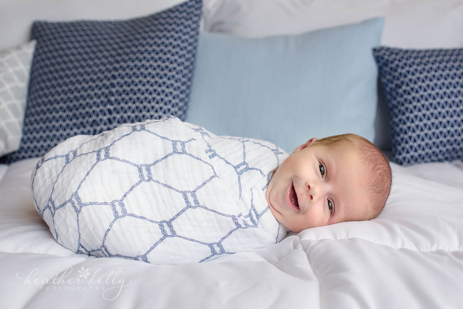 awake newborn boy swaddled on bed. shelton ct newborn photography