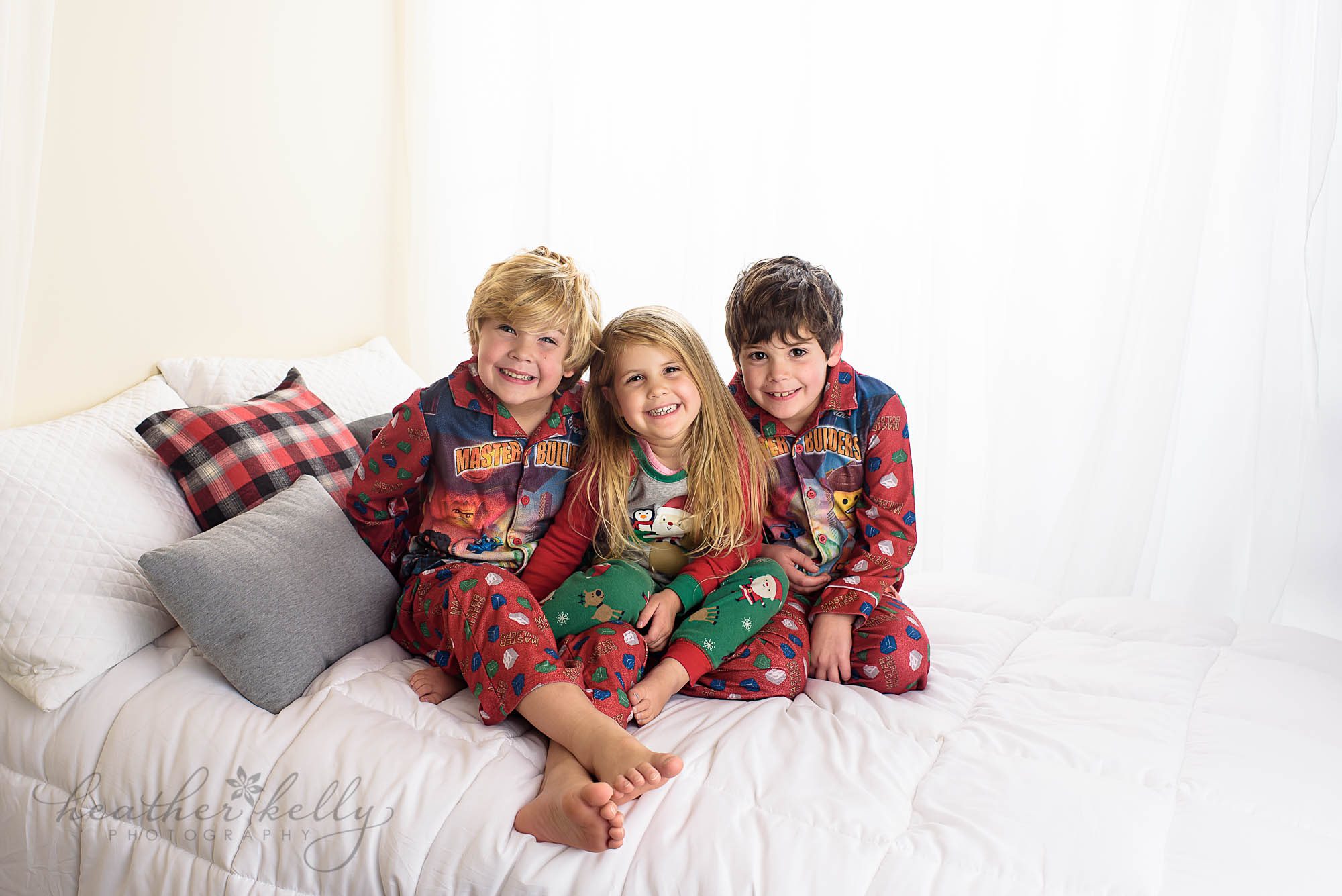 kids in pajamas on bed backlit. children photography studio newtown ct