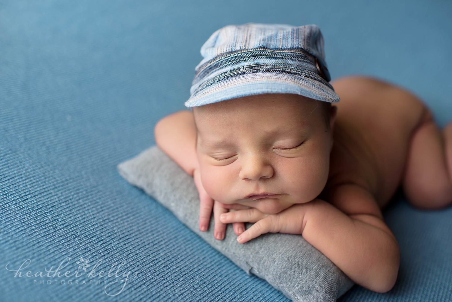 close up newborn boy with visor. derby baby boy. CT newborn photography.