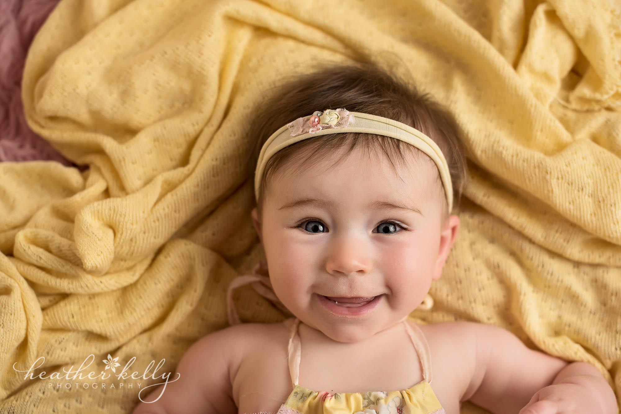 close up of 6 month baby yellow and pink. ridgefield baby