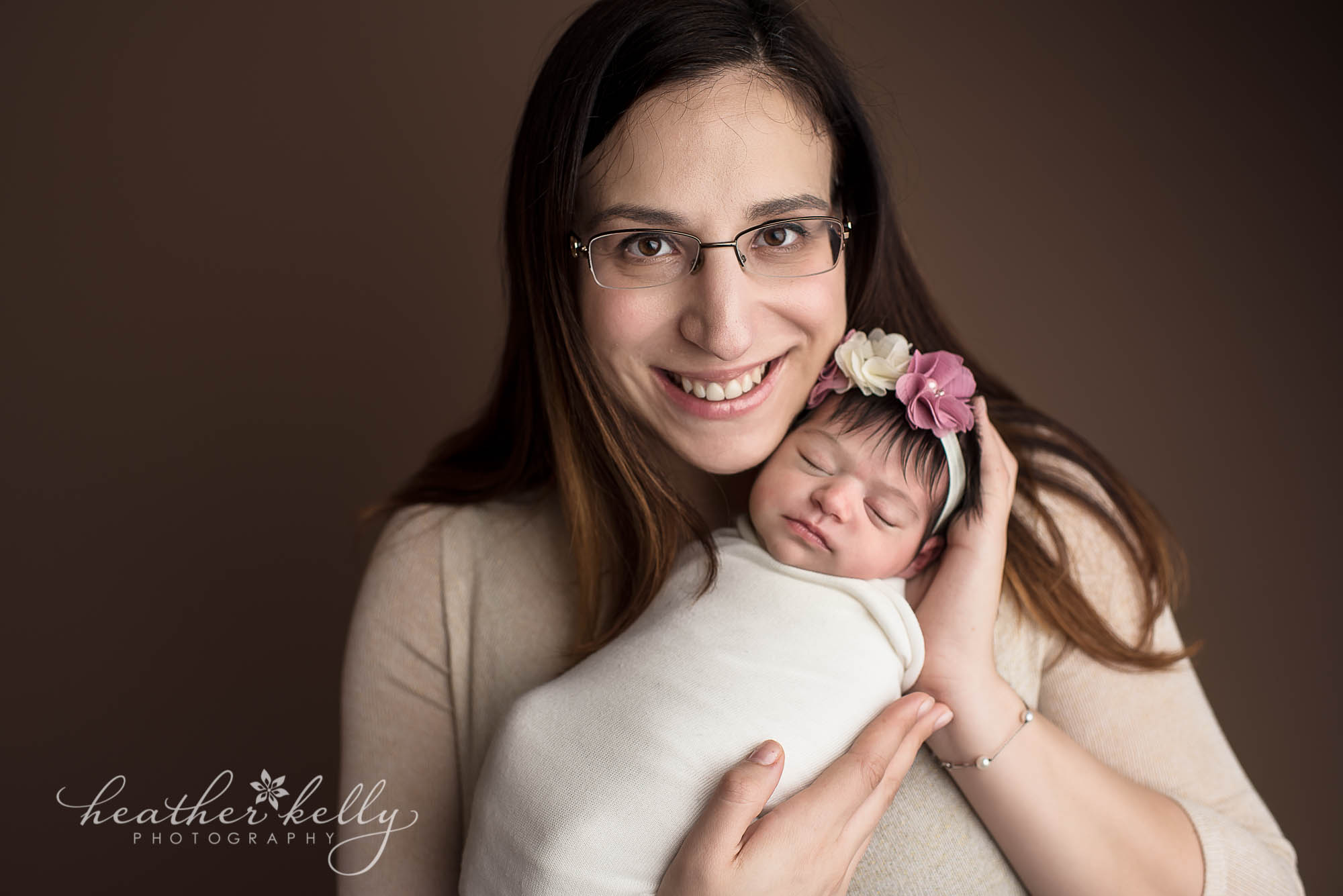 mom holding newborn daughter. milford ct newborn photography