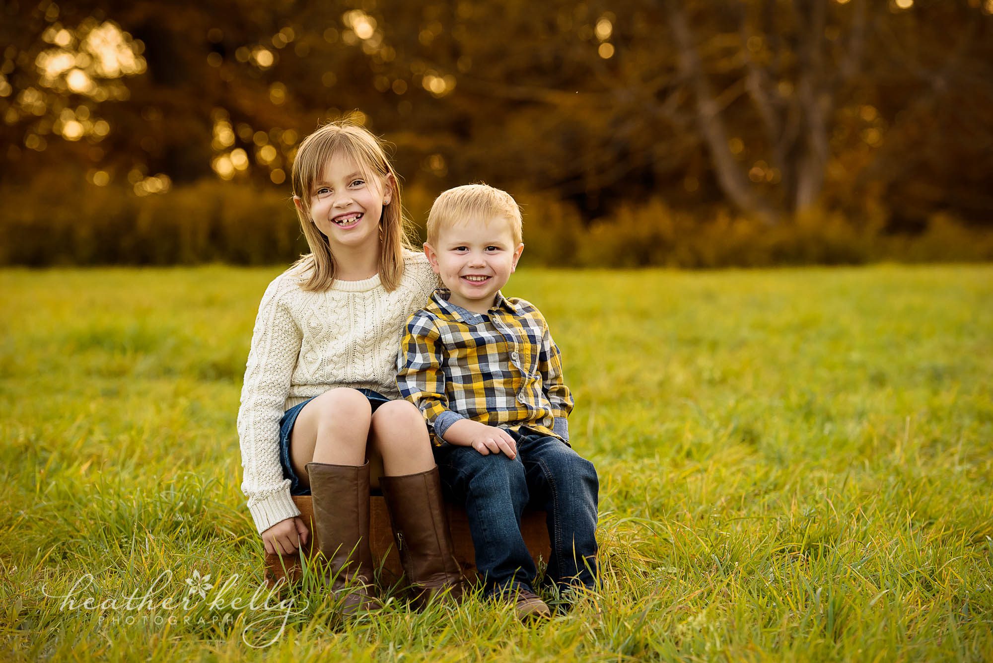 brother and sister sitting on crate in field. fall family photography newtown ct