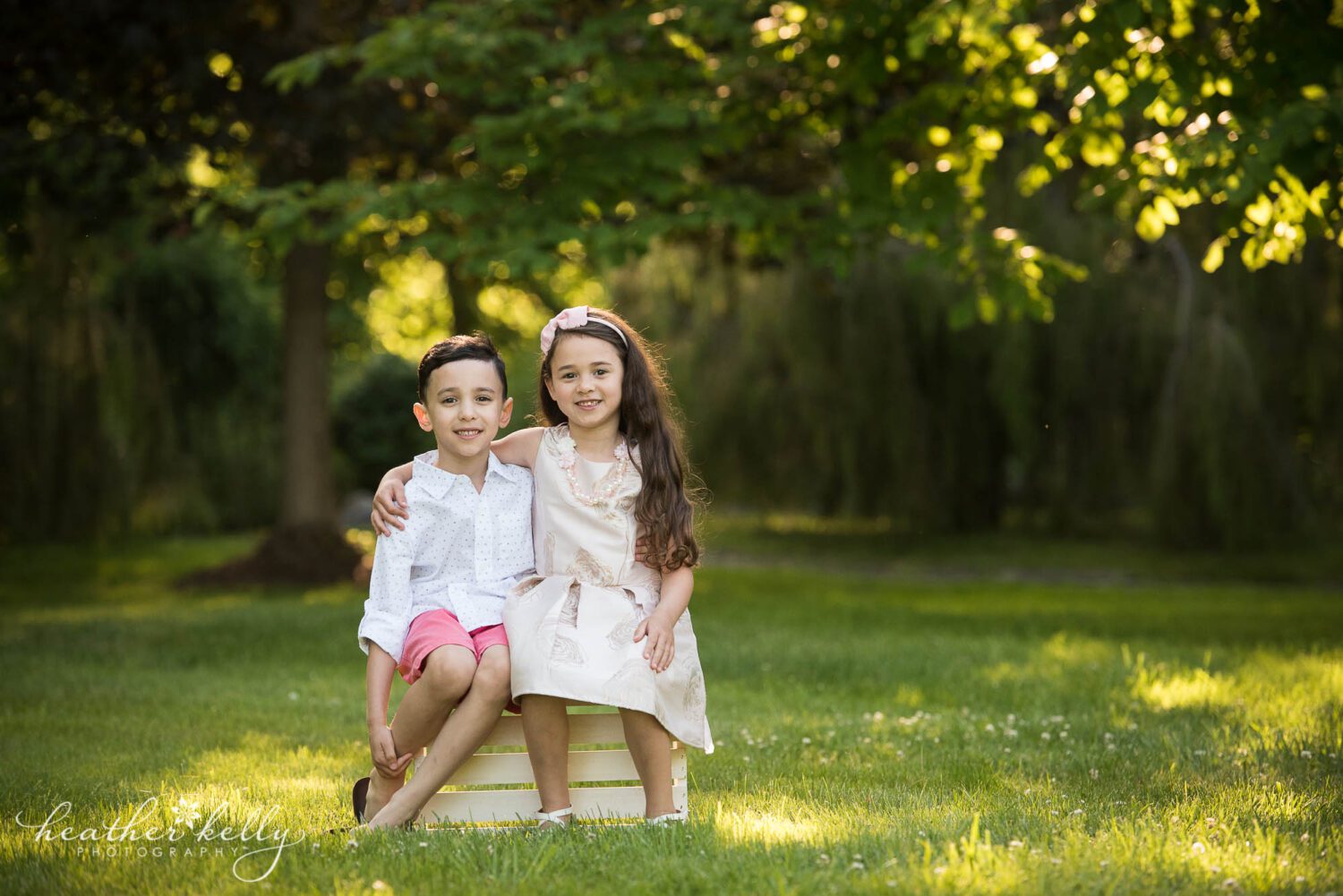 brother and sister sitting on a white crate during their monroe ct family photography session