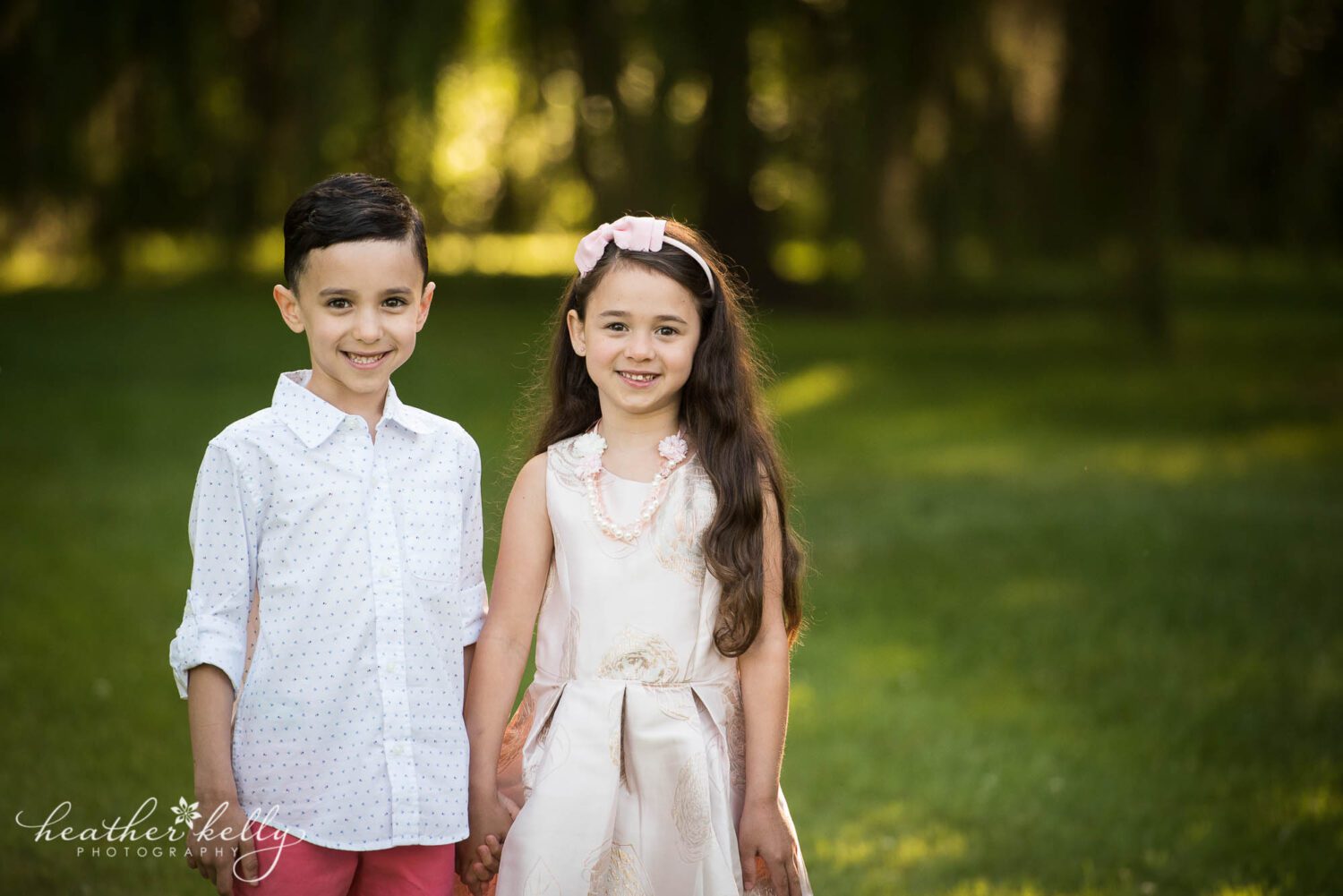 brother and sister stand and hold hands during their spring time monroe ct family photography session