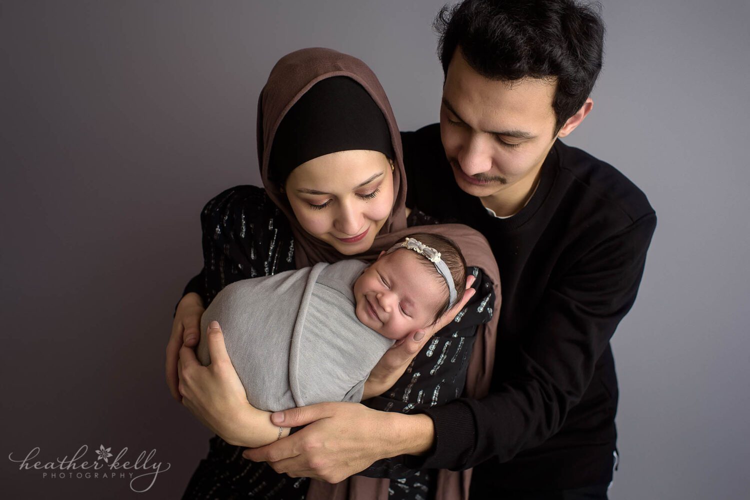 mom and dad holding their newborn baby girl. Newborn photography and family