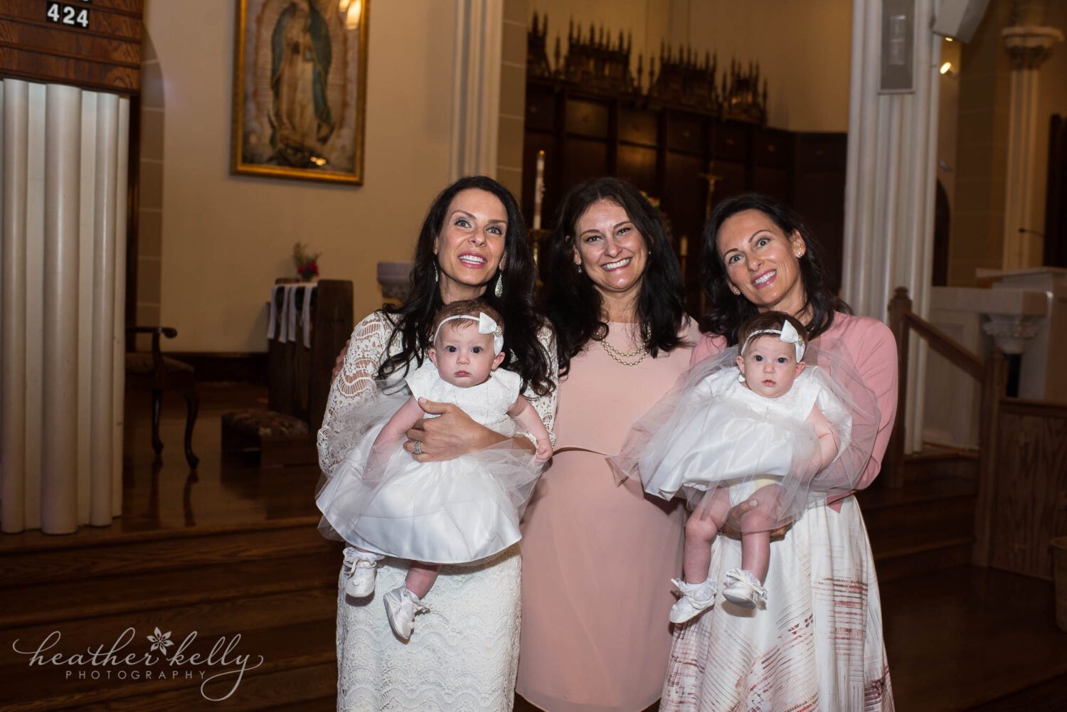 Three sisters and two baby twins at a church for a baptism. 