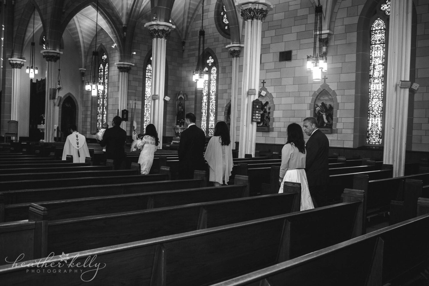family members walking down the church aisle during a baptism in wallingford ct. 
