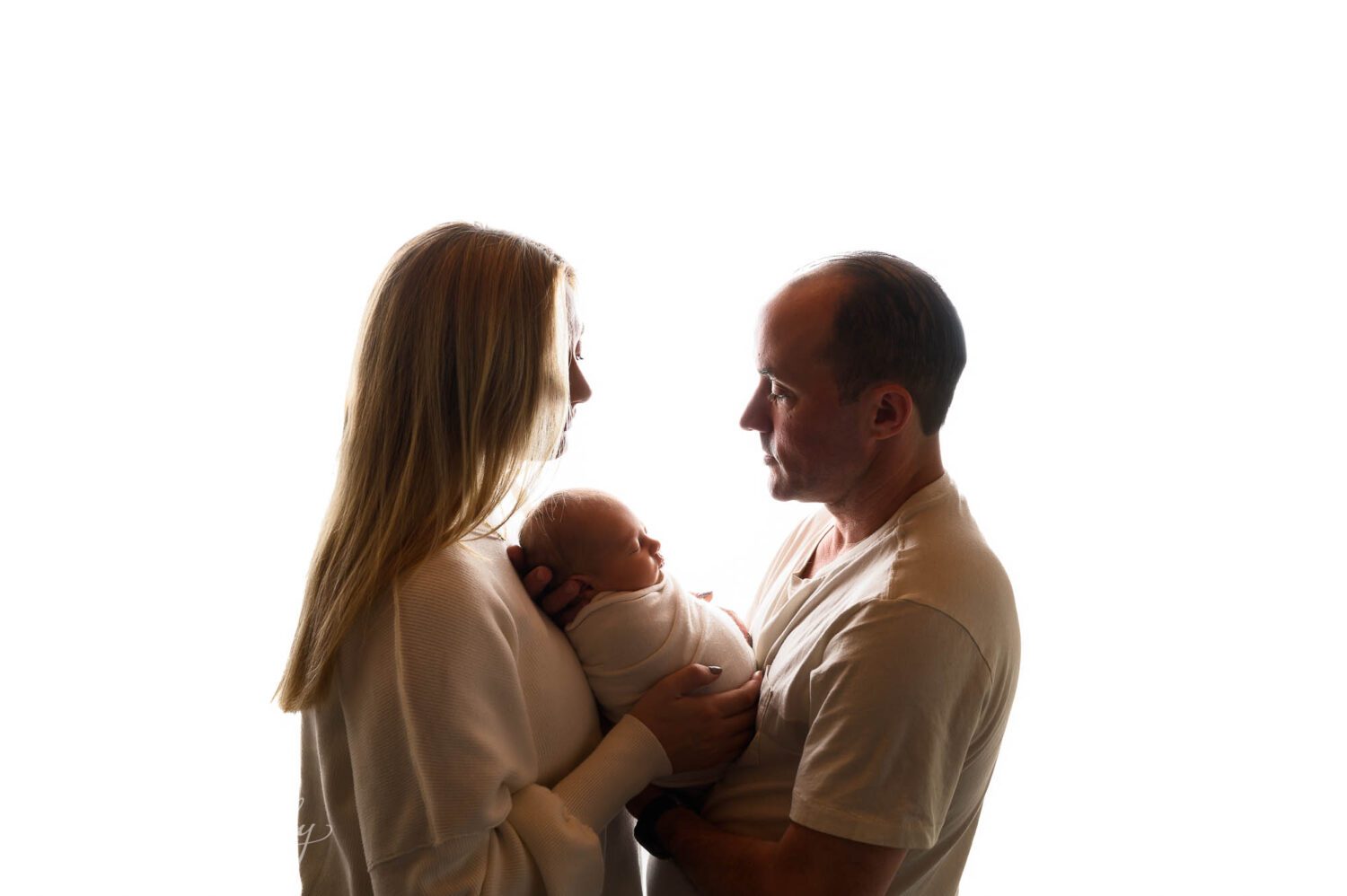 A new family of three pose for their bridgeport ct newborn photography session. 