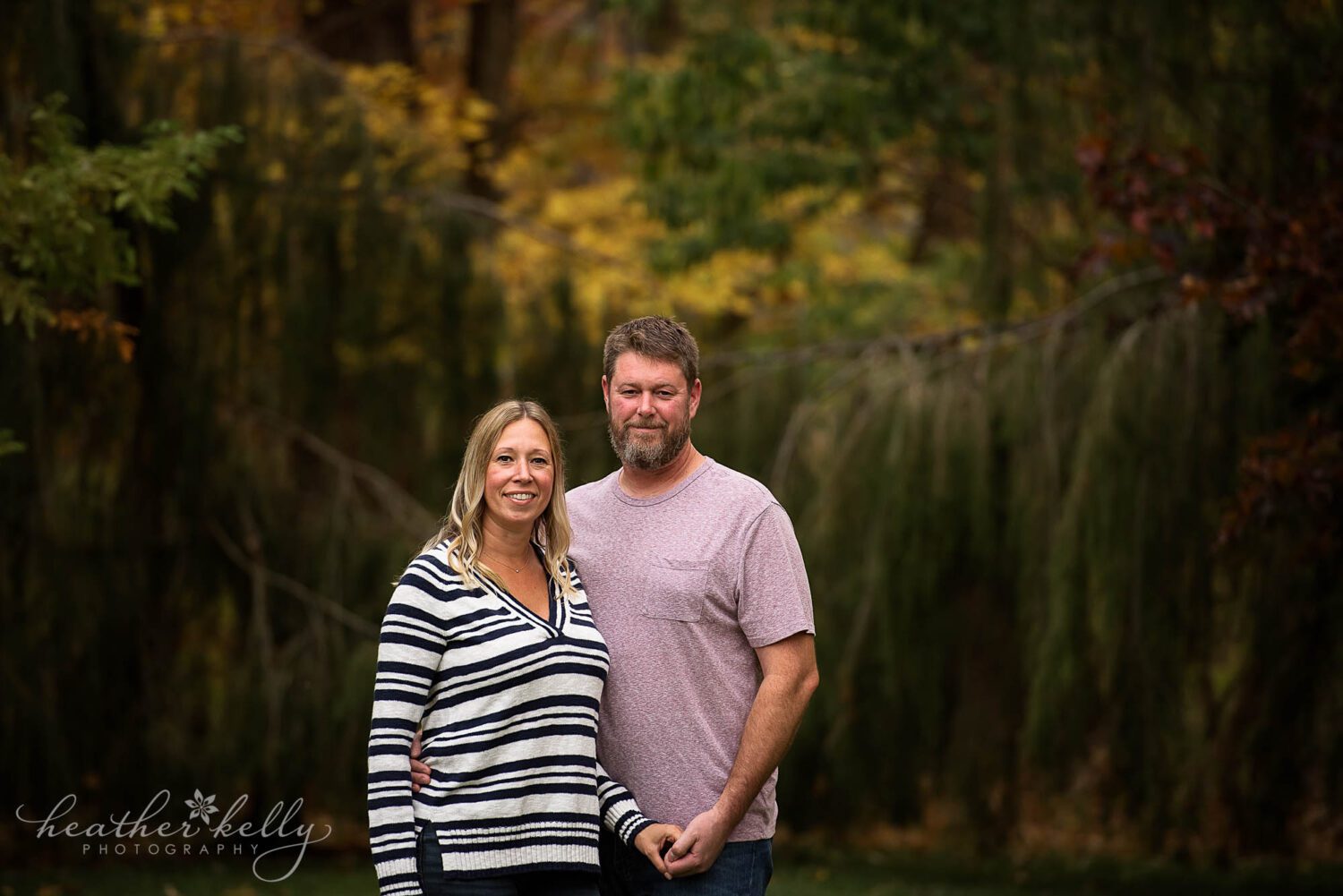 A newtown couple looking and laughing together during a couples photography session. 