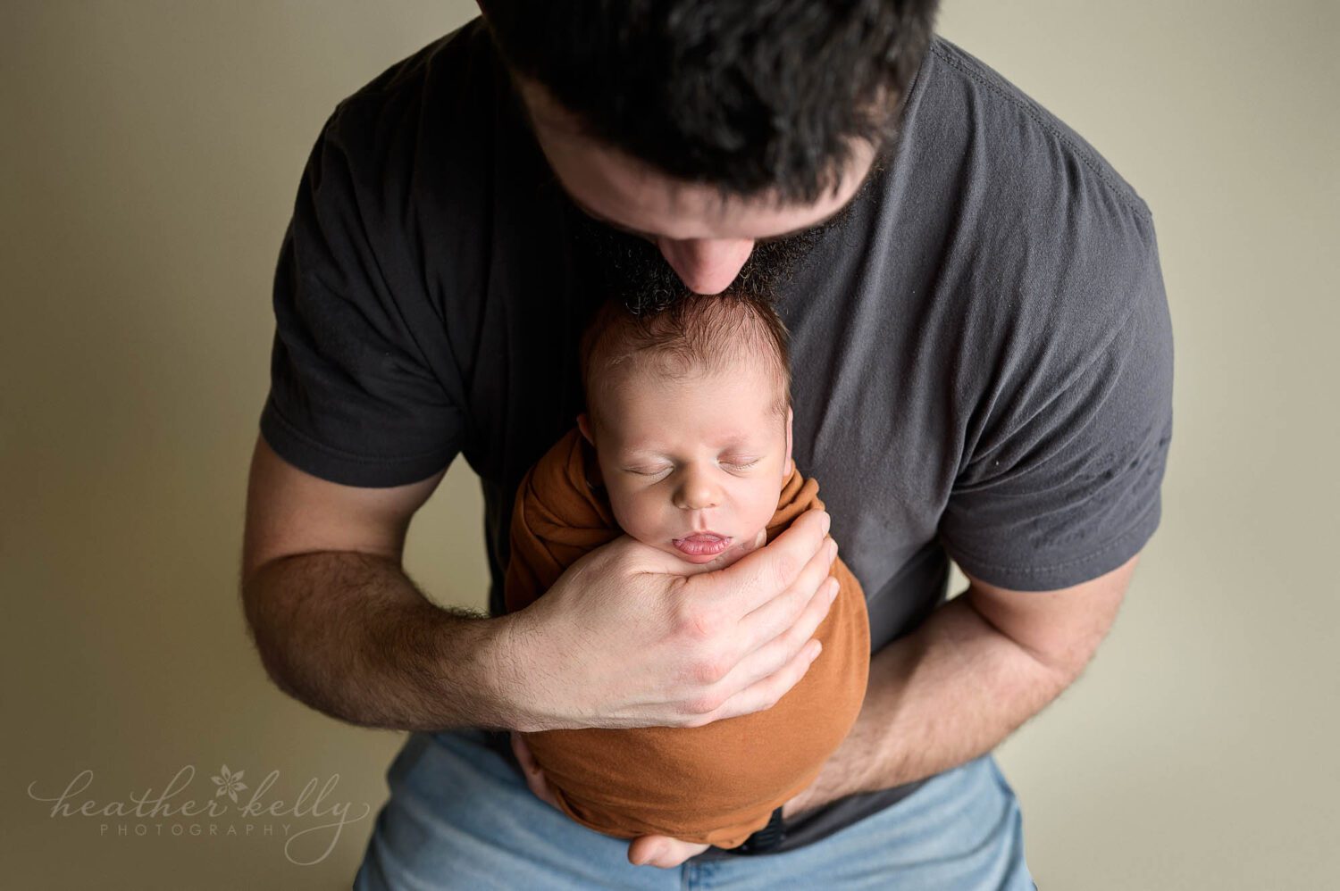 a connecticut dad holding his newborn son