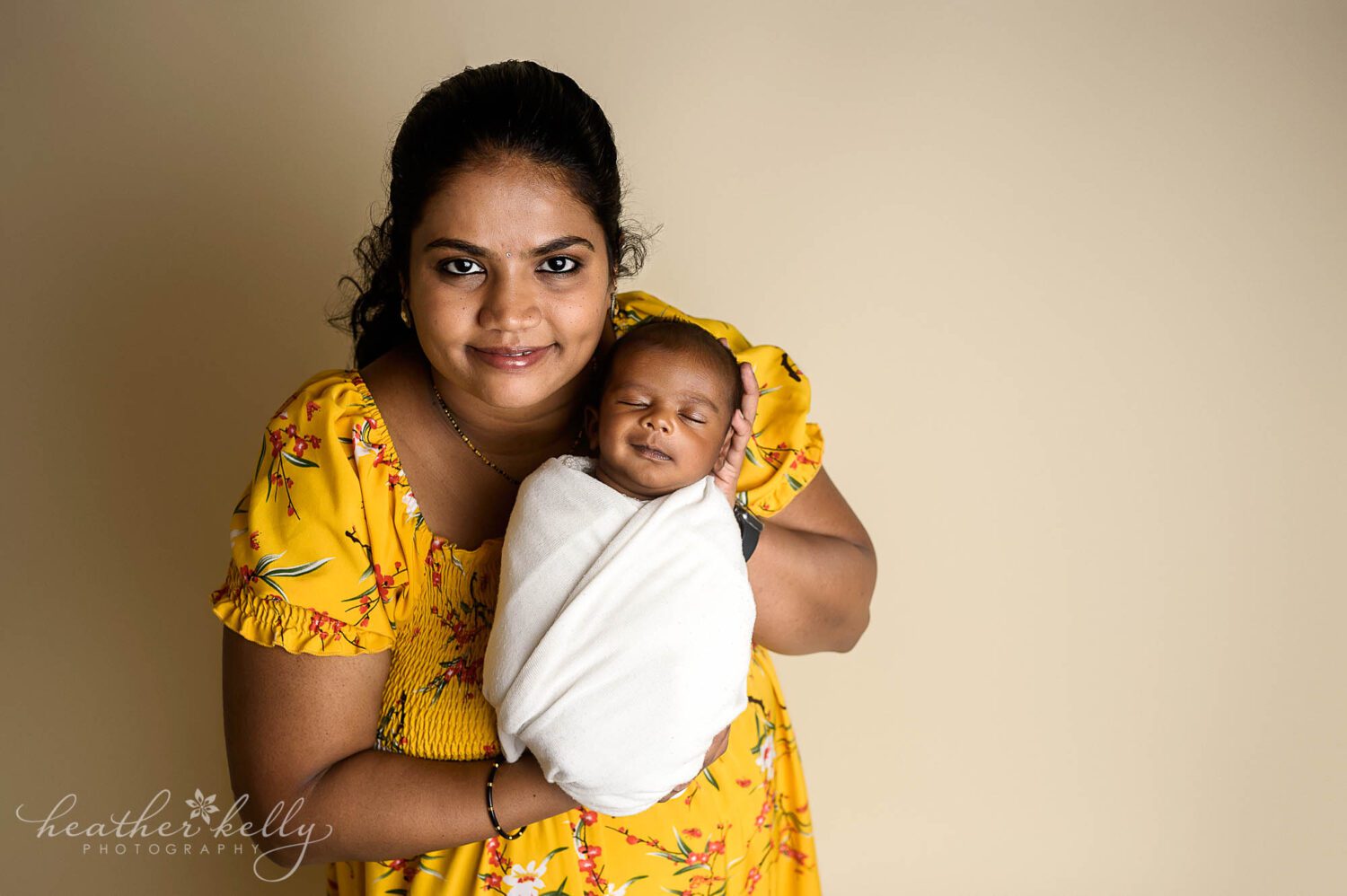 a mom holding her newborn boy 