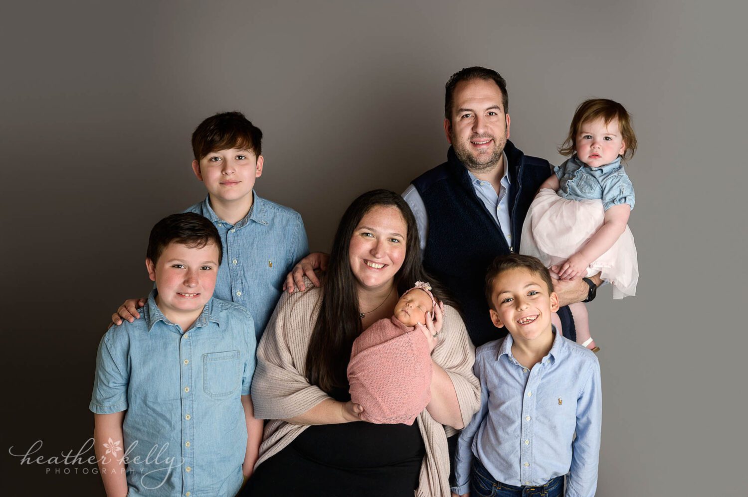 a family of 7 looks at the camera during their newtown ct photography session. 