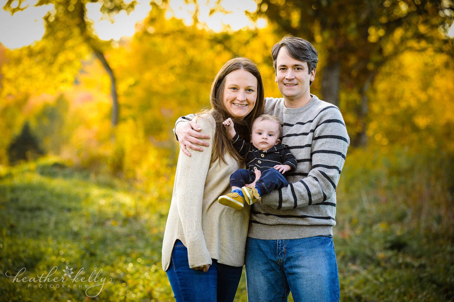 a family of 3 during their fall family photography session in ct