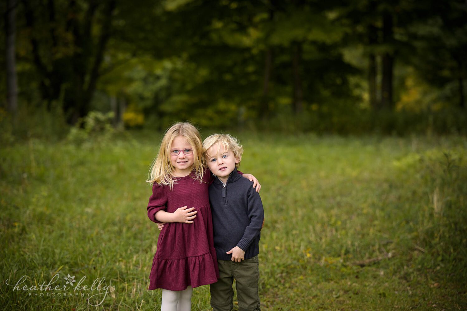 a bethel ct family photography session of a brother and sister. They have their arms around each other. 