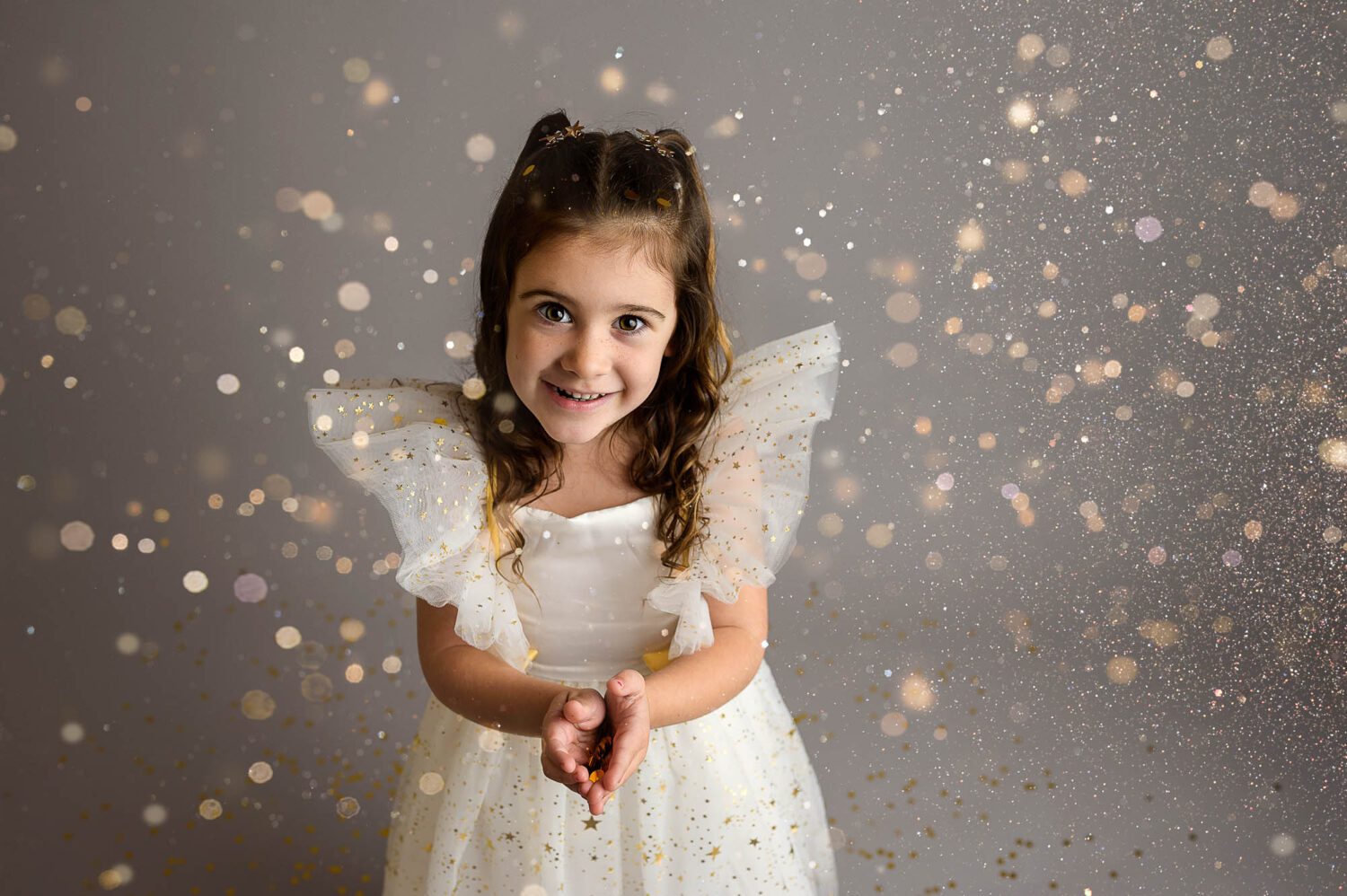 a young child throws glitter during a glitter mini session in ct 